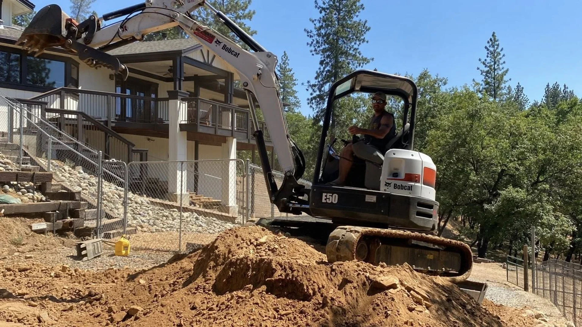 Professional excavation and land clearing services in Northern California - Brushtech equipment working on hillside property in El Dorado County