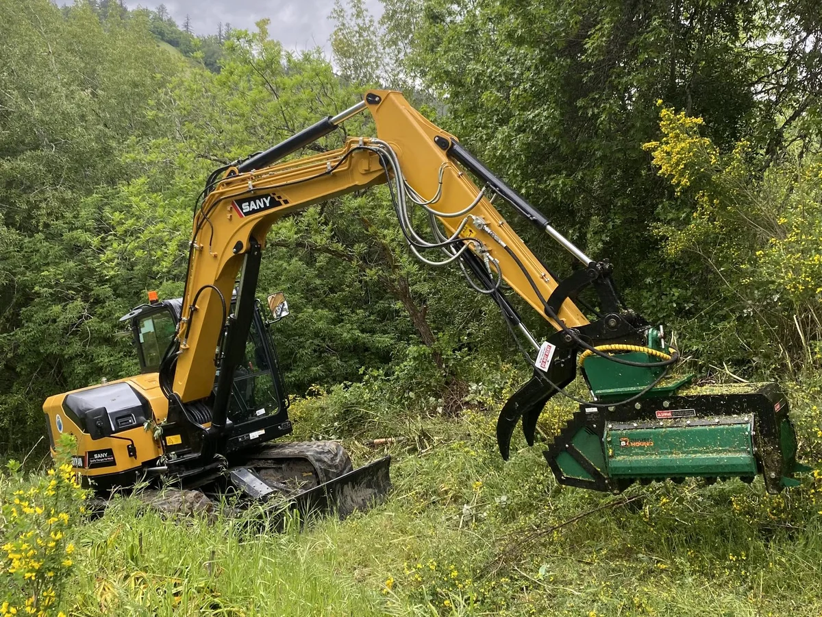 Forestry mulcher and excavator performing land clearing and vegetation management in Placer County