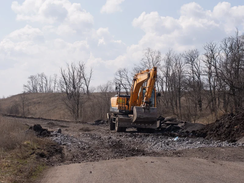 Professional excavator performing road construction and grading for property access in Northern California