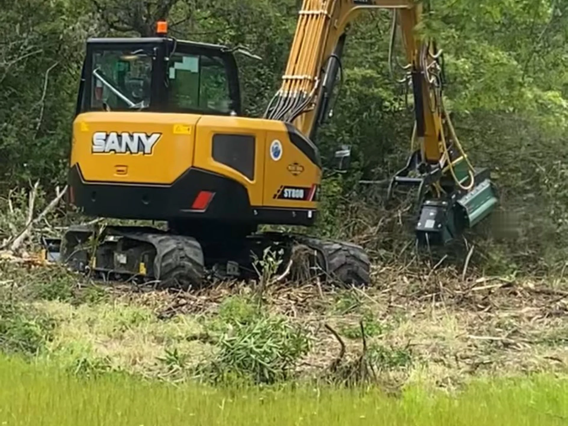Forestry mulcher attachment on excavator for efficient land clearing in Northern California